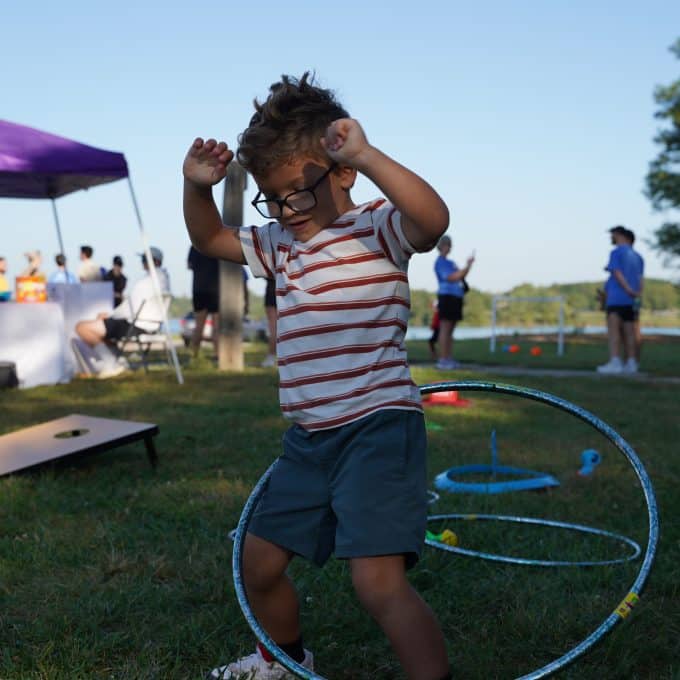 Young boy uses a hula hoop