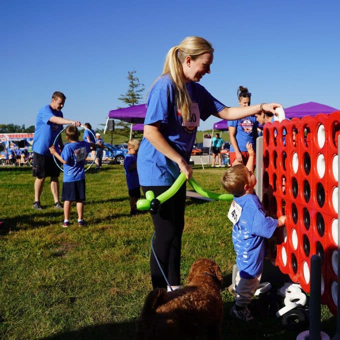 Woman and child play a large version of connect four