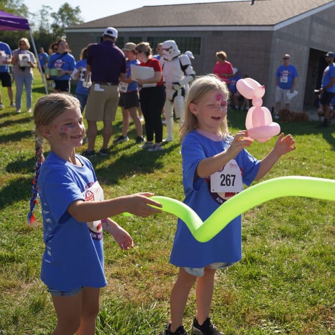 young girls play with balloons