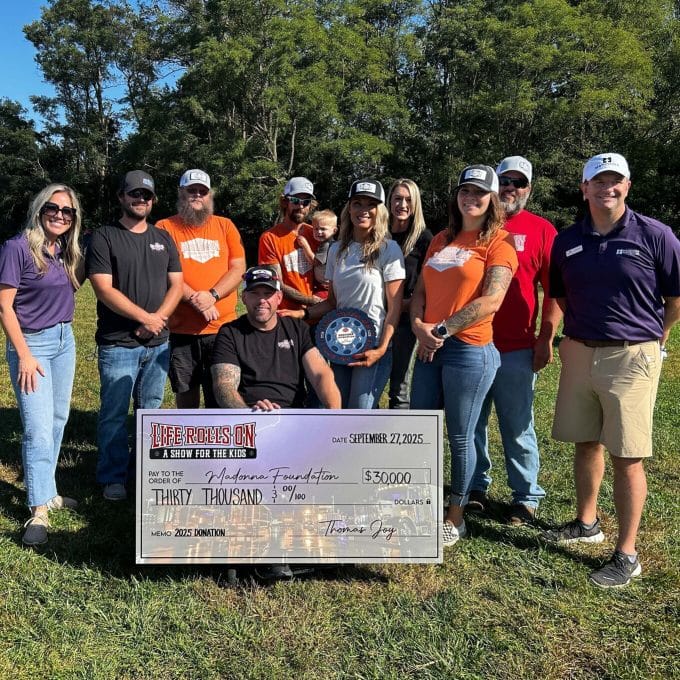 local group poses for picture with a donation check for the Madonna Foundation
