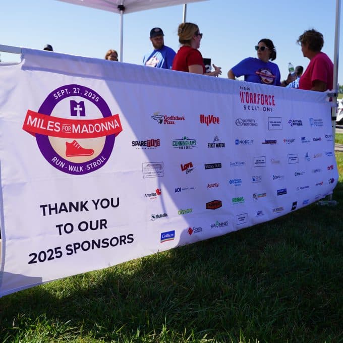 Banner with Miles for Madonna is displayed under tent